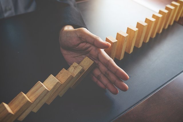 problem-solving-close-up-view-hand-business-woman-stopping-falling-blocks-table-concept-about-taking-responsibility.jpg