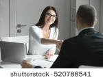 stock-photo-friendly-smiling-businessman-and-businesswoman-handshaking-over-the-office-desk-after-pleasant-talk-520788541.jpg
