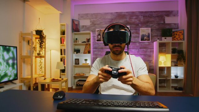 pov-young-man-playing-online-games-with-virtual-reality-headset-wireless-controller_482257-29605.jpg