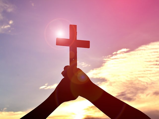 faith-christian-cross-hands-sky-sun-glare_credit-shutterstock.jpg