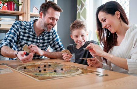 96956094-happy-family-playing-board-game-at-home-happiness-concept.jpg