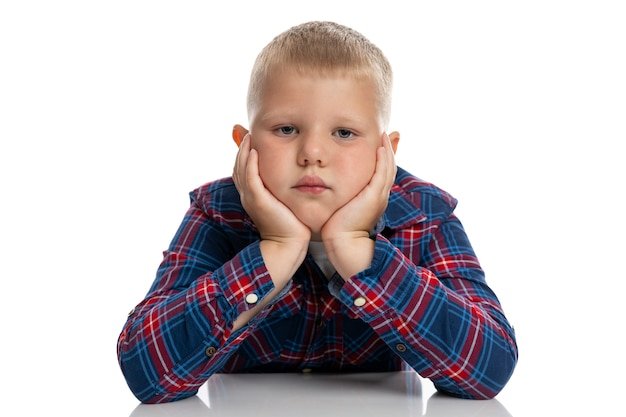 a-fat-sad-boy-sits-at-a-table-with-his-head-in-his-hands-schoolboy-in-a-plaid-shirt-back-to-school-isolated-close-up_120897-1934.jpg