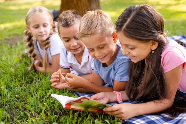 smiley-friends-sitting-blanket-reading_23-2148308679.jpg