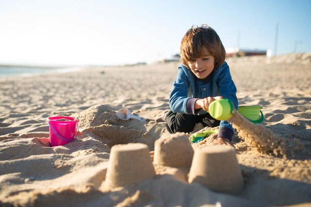 boy-building-sandcastle-schoolboy-playing-beach-summer-holidays_74855-20277.jpg