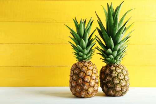 bigstock-Ripe-Pineapples-On-A-White-Woo-121853795.jpg