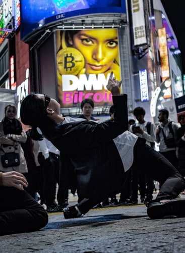 Bitcoin logo behind dancer unplash.jpg