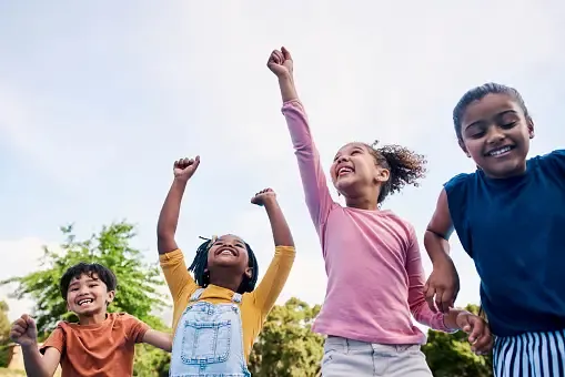 children-freedom-and-energy-with-friends-cheering-together-outdoor-while-having-fun-during.webp