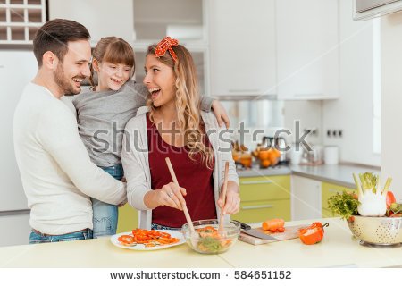 stock-photo-happy-young-family-preparing-lunch-in-the-kitchen-and-enjoying-together-584651152.jpg