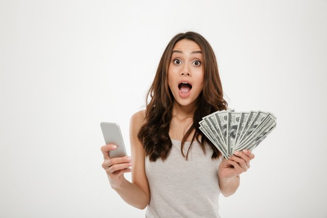 portrait-attractive-brunette-female-30s-winning-lots-money-dollar-currency-using-her-smartphone-being-joyful-white.jpg