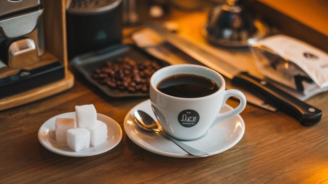 a-photo-of-a-white-cup-with-black-coffee-and-a-smaqA.jpeg