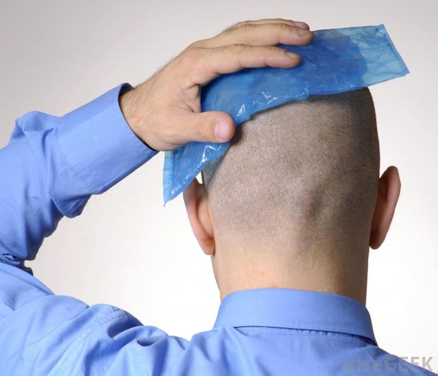 man-in-blue-shirt-with-ice-pack-against-back-of-head.jpg