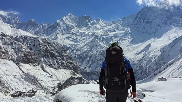 hiker-walking-in-annapurna-valley-mountain-snow-peak-in-background-himalayas-nepal-travel-hd-video_bh69tegy__F0000.png