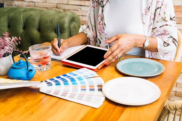 woman-writing-notebook-with-digital-tablet-plates-color-swatch-wooden-table_23-2147936296.jpg