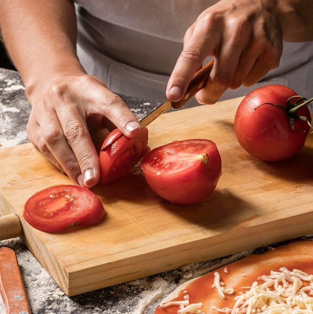 close-up-cook-cutting-tomato_23-2148584836.jpg