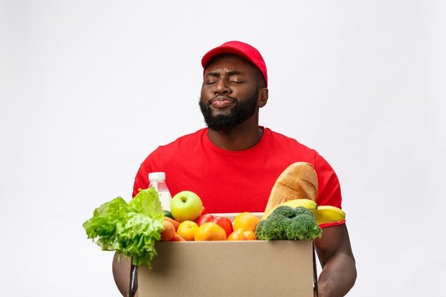 delivery-service-handsome-african-american-delivery-man-carrying-package-box-grocery-food-drink-from-store_1258-39820.jpg