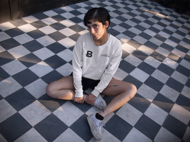 sweatshirt-mockup-of-a-woman-sitting-cross-legged-on-a-checkered-floor-18280.png