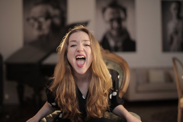 woman-in-black-polka-dots-shirt-sitting-on-chair-3783802.jpg