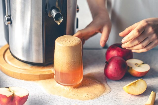 woman-makes-apple-juice-home-with-juicer_169016-52099.jpg