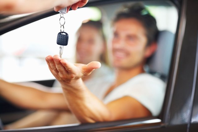 blurred-couple-with-man-receiving-car-key-from-royalty-free-image-1591274673.jpg