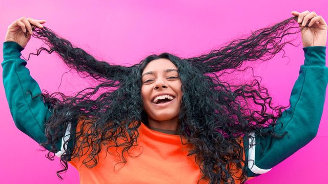 Happy-woman-holding-out-hair-1296x728-header-1296x728.jpg