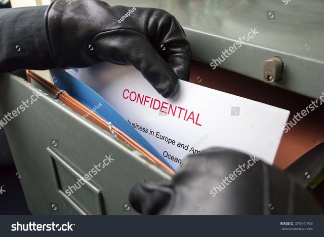 stock-photo-thief-stealing-confidential-files-in-an-office-373441963.jpg