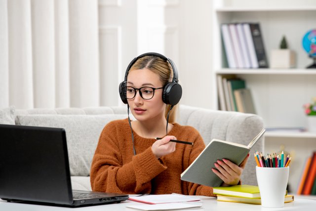 student-online-cute-girl-glasses-sweater-studying-computer-writing-down-notes.jpg