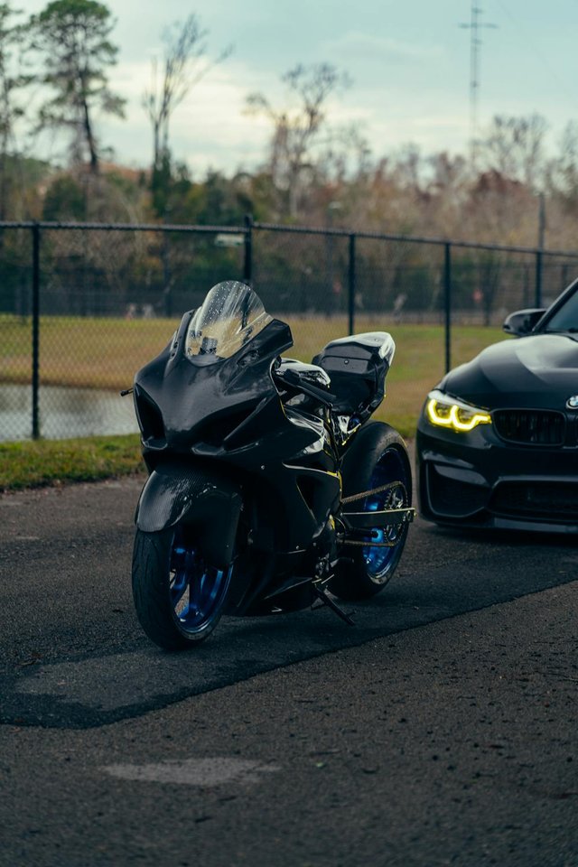 free-photo-of-sleek-motorcycle-and-luxury-car-on-asphalt-road.jpeg