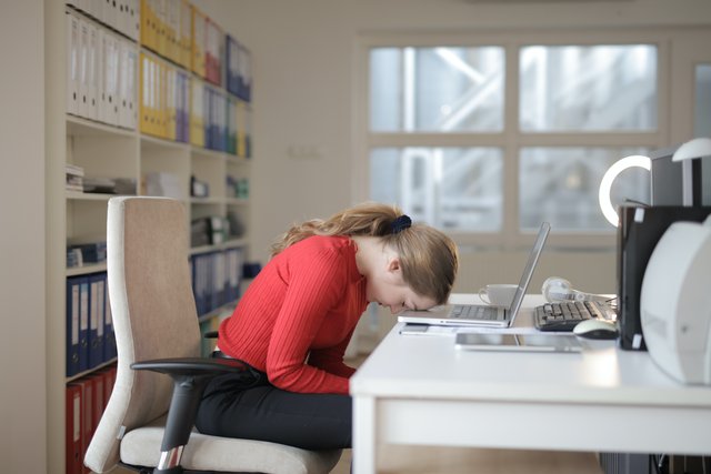 woman-in-red-long-sleeve-shirt-sitting-on-chair-while-3791134.jpg