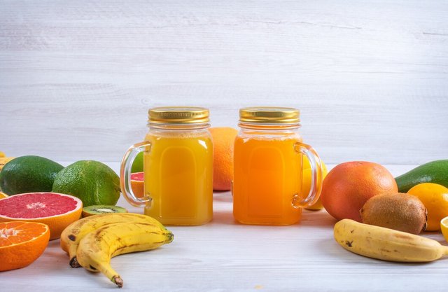 orange-lemon-juice-surrounded-by-different-colorful-fresh-citrus-fruits-white-table_176474-395.jpg