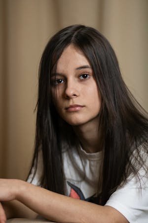 free-photo-of-girl-with-long-dark-hair-posing-against-a-beige-background.jpeg