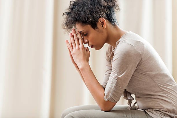 african-american-woman-praying-at-home-picture-id493507934.jpg