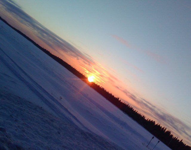 beautiful colors in sky and snow field sun touching the horizon.JPG