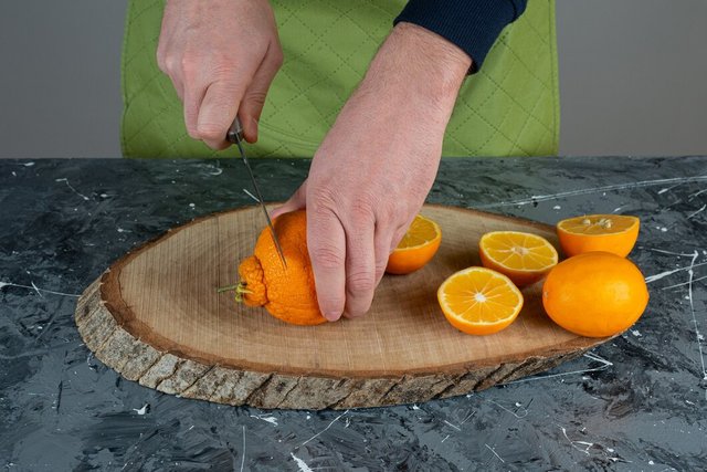 male-hands-cutting-fresh-lemon-marble-table_2831-8191.jpg