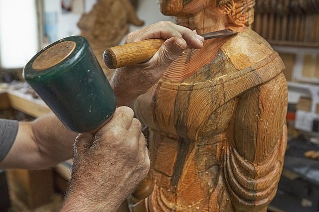 a-wood-carver-standing-in-his-workshop-using-hand-2023-11-27-05-23-45-utc-large.jpg