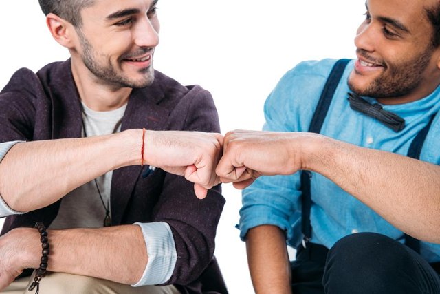 stock-photo-friends-smiling-and-doing-fist.jpg