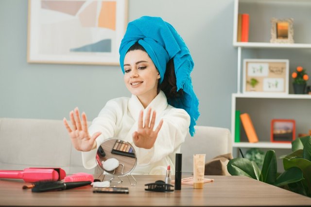 smiling-young-girl-wrapped-hair-towel-dry-gel-nails-sitting-table-with-makeup-tools-living-room_141793-123504.jpg