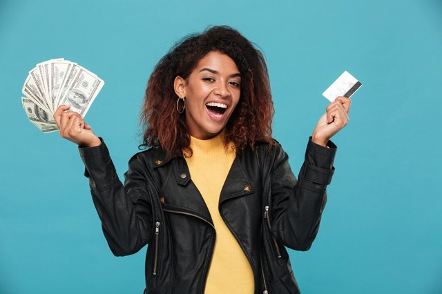 happy-african-woman-leather-jacket-holding-money_171337-14276.jpg