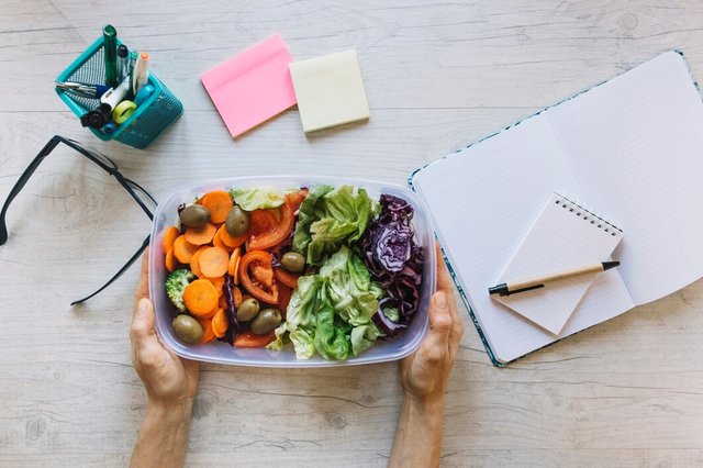 crop-hands-holding-box-with-salad-table_23-2147778450.jpg