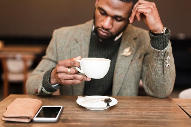 handsome-man-holding-cup-with-coffee_23-2148448937.jpg