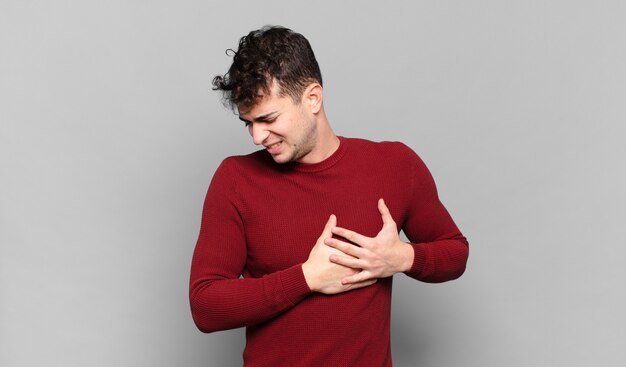 young-man-looking-sad-hurt-heartbroken-holding-both-hands-close-heart-crying-feeling-depressed_1194-171628.jpg