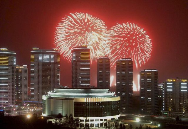 Fireworks explode in the sky over high rise buildings in Pyongyang in this undated photo released January 1, 2015. REUTERS.KCNA.jpg