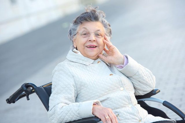 old-woman-wheelchair-outdoors-smiling-130824258.jpg