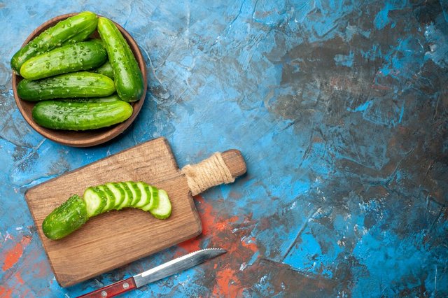 top-view-fresh-green-cucumbers-inside-plate-blue-background_140725-138932.jpg