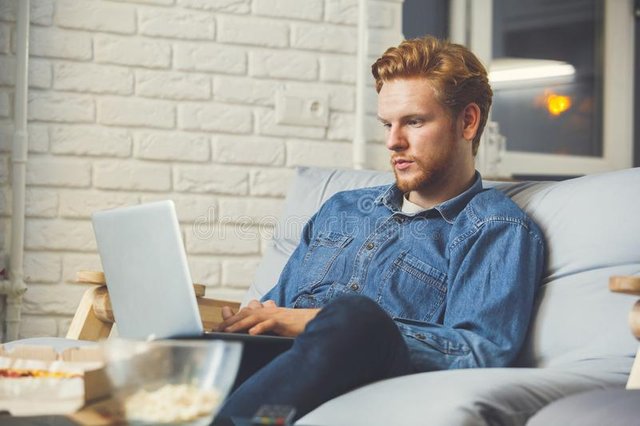 guy-watching-sport-football-tv-alone-making-bets-online-laptop-concentrated-man-home-bet-108544077.jpg