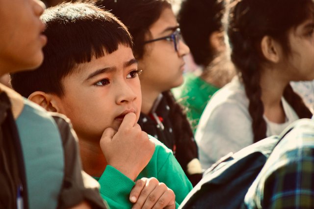 free-photo-of-thoughtful-child-among-peers-in-group-setting.jpeg