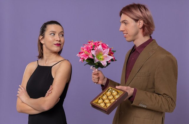 smiling-young-handsome-man-holding-bouquet-flowers-chocolate-box-looking-pretty-young-woman_141793-124347.jpg