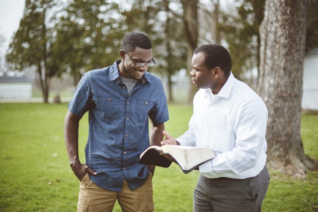 african-american-male-friends-standing-park-discussing-bible.jpg