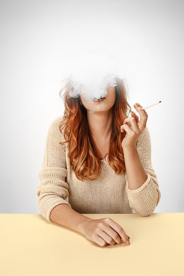 tranquil-woman-sitting-smoking-resting-table-cloud-smoke-covering-her-face-copy-space.jpg