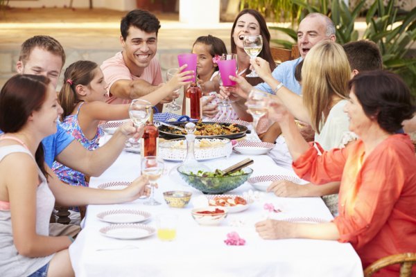 depositphotos_64583561-stock-photo-large-family-enjoying-meal.jpg