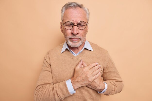 stressed-mature-man-touches-chest-suffers-from-heart-attack_273609-52468.jpg